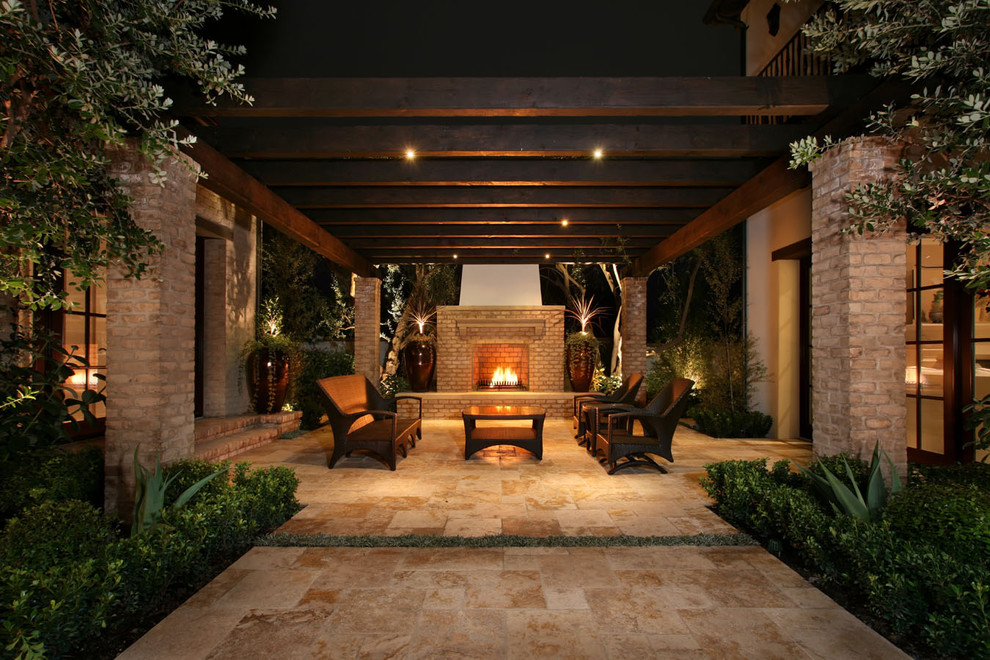 Photo of a contemporary courtyard patio in Los Angeles with a fire feature and a pergola.