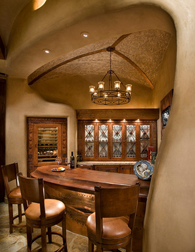 Design ideas for a mid-sized traditional seated home bar in Phoenix with glass-front cabinets, medium wood cabinets and wood benchtops.