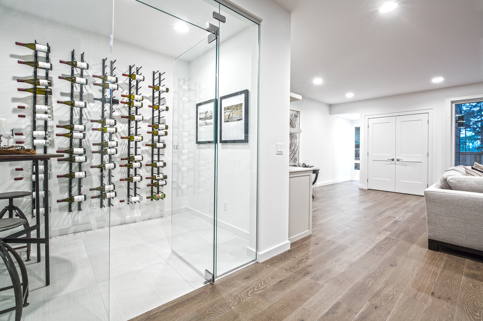 This is an example of a small transitional wine cellar in Seattle with porcelain floors, storage racks and white floor.