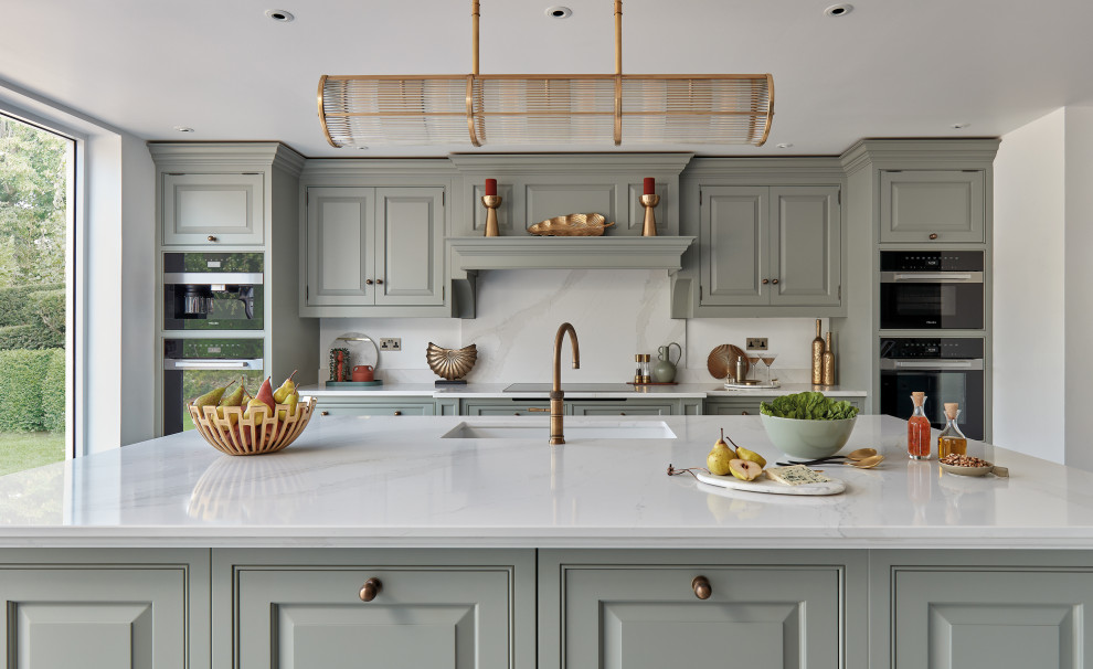 Design ideas for a mid-sized traditional galley separate kitchen in Other with a farmhouse sink, shaker cabinets, green cabinets, quartzite benchtops, white splashback, engineered quartz splashback, black appliances, with island and white benchtop.