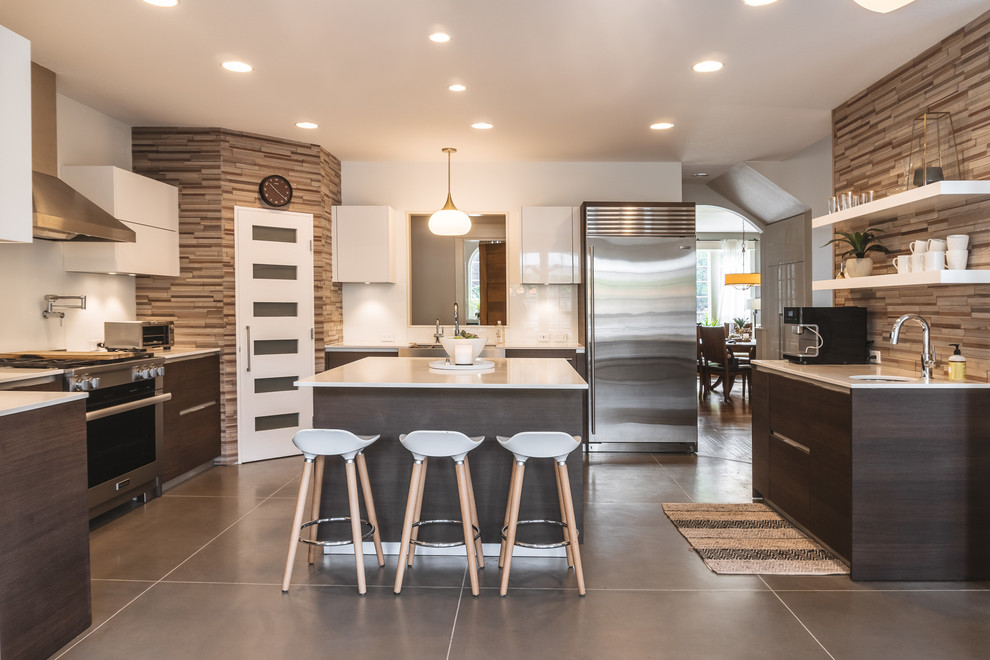 This is an example of a contemporary u-shaped separate kitchen in Portland with flat-panel cabinets, dark wood cabinets, brown splashback, matchstick tile splashback, stainless steel appliances, concrete floors, with island and grey floor.
