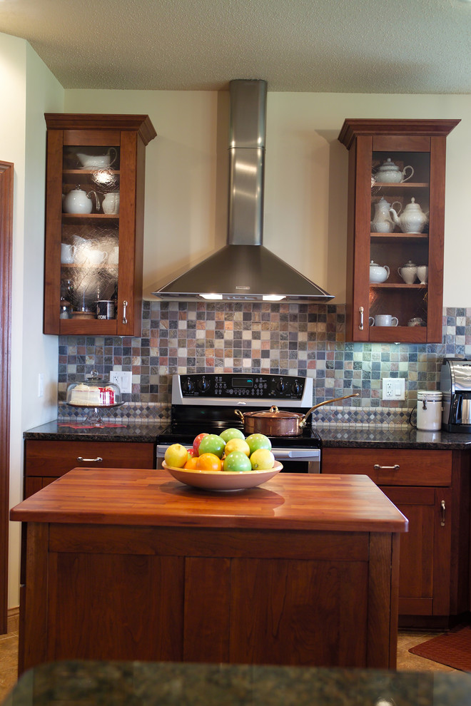 Example of a large transitional u-shaped porcelain tile open concept kitchen design with an undermount sink, recessed-panel cabinets, dark wood cabinets, granite countertops, gray backsplash, ceramic backsplash, stainless steel appliances and two islands