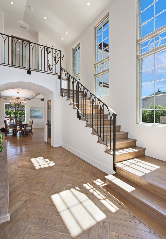 This is an example of a beach style entryway in Orange County with white walls.
