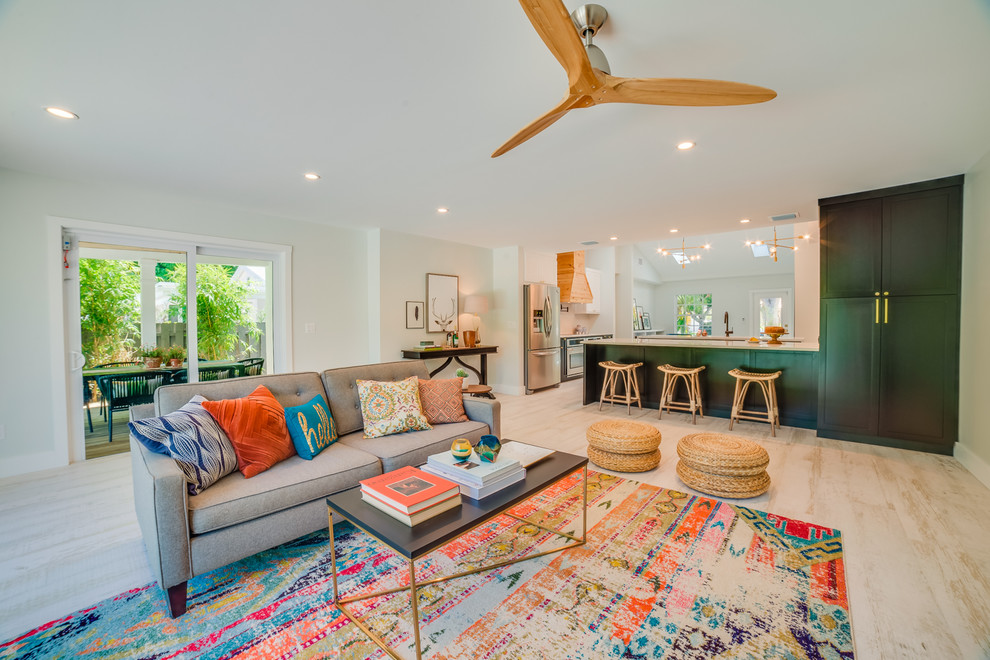 Eclectic open concept beige floor living room photo in Miami with white walls