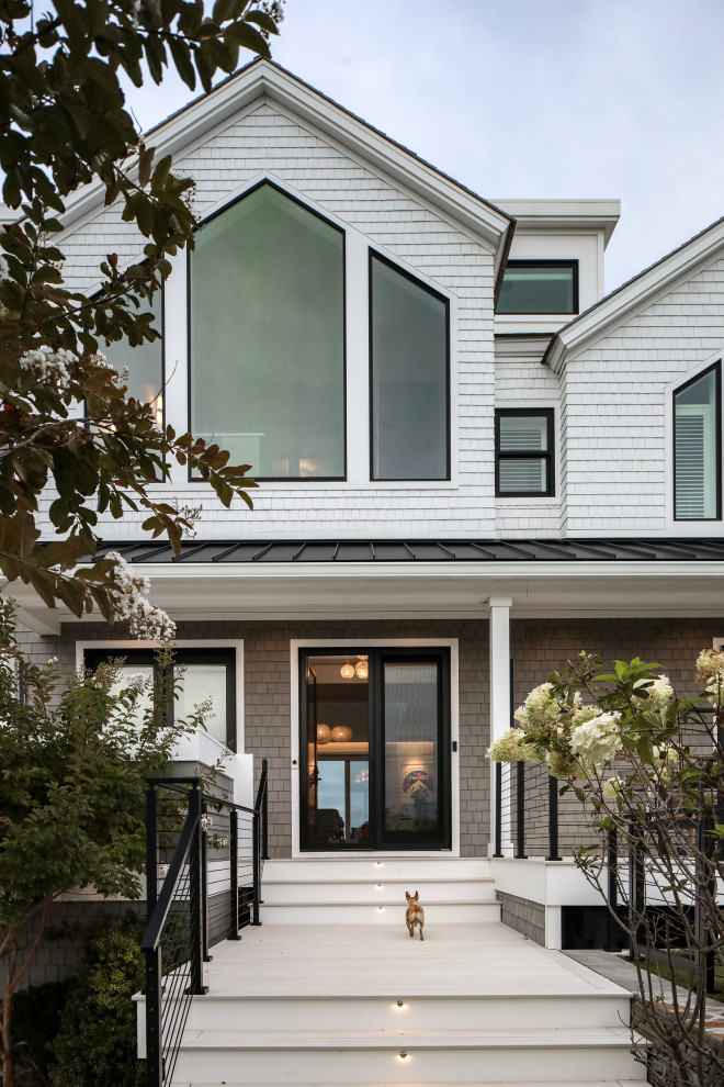 Inspiration for a mid-sized coastal multicolored three-story concrete and shingle exterior home remodel in New York