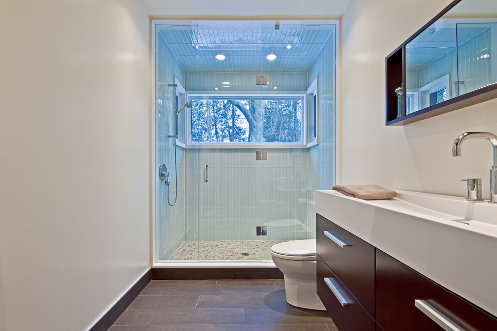 Inspiration for a country bathroom in Toronto with a trough sink, flat-panel cabinets, dark wood cabinets, an alcove shower, blue tile and glass tile.