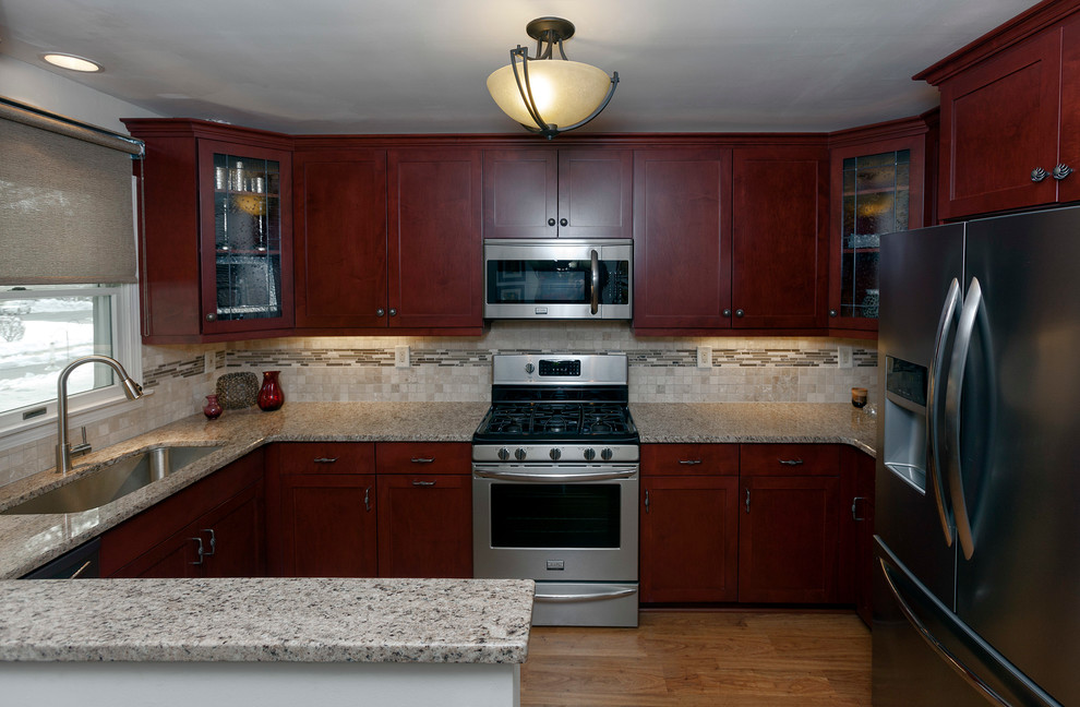 Example of a mid-sized transitional u-shaped light wood floor eat-in kitchen design in Miami with an undermount sink, shaker cabinets, medium tone wood cabinets, granite countertops, beige backsplash, matchstick tile backsplash, stainless steel appliances and no island