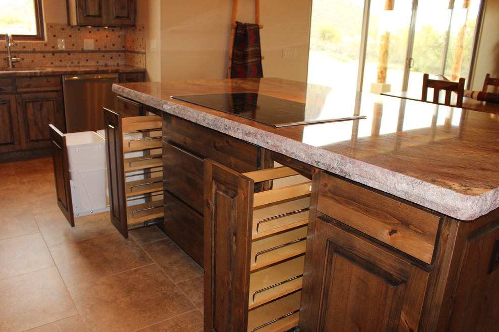 Large mountain style porcelain tile eat-in kitchen photo in Phoenix with a single-bowl sink, flat-panel cabinets, distressed cabinets, multicolored backsplash, stainless steel appliances and an island