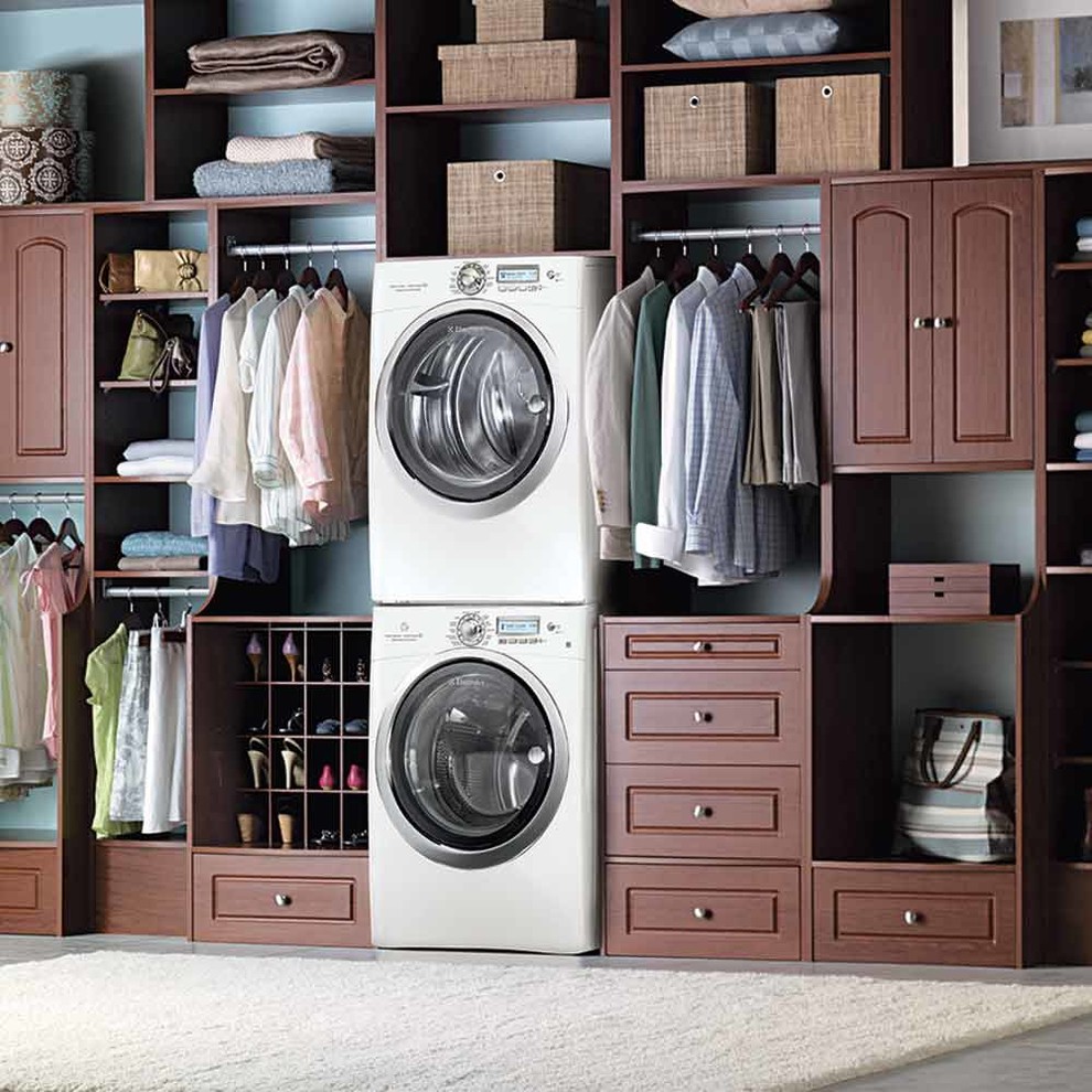 This is an example of a contemporary laundry room in New York with dark wood cabinets.
