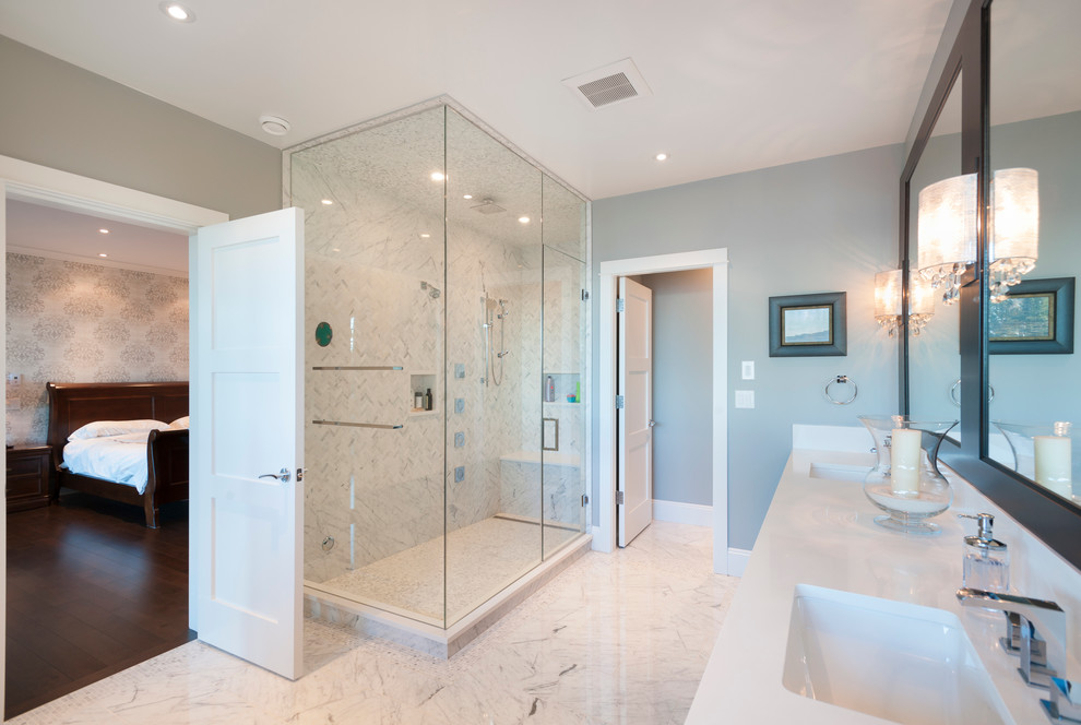 Inspiration for a large transitional master bathroom in Vancouver with an undermount sink, shaker cabinets, dark wood cabinets, marble benchtops, a freestanding tub, a two-piece toilet, white tile, stone tile, blue walls and marble floors.