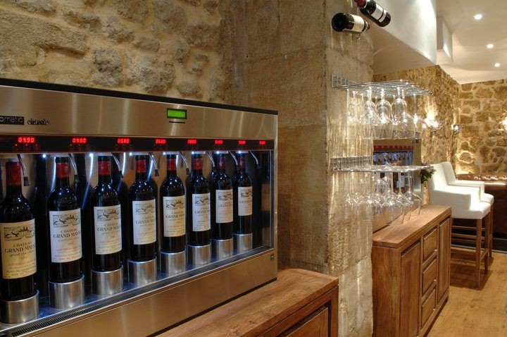 This is an example of a small contemporary wine cellar in Bordeaux with medium hardwood floors and display racks.