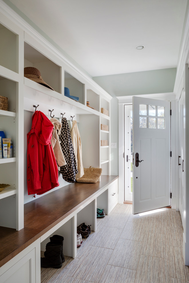 Entryway - large transitional ceramic tile entryway idea in Boston with blue walls and a white front door