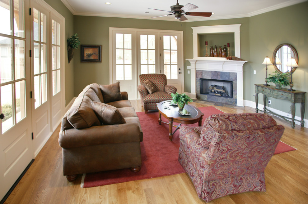 Photo of a mid-sized traditional formal open concept living room in Nashville with green walls, medium hardwood floors, a tile fireplace surround, no tv and a corner fireplace.