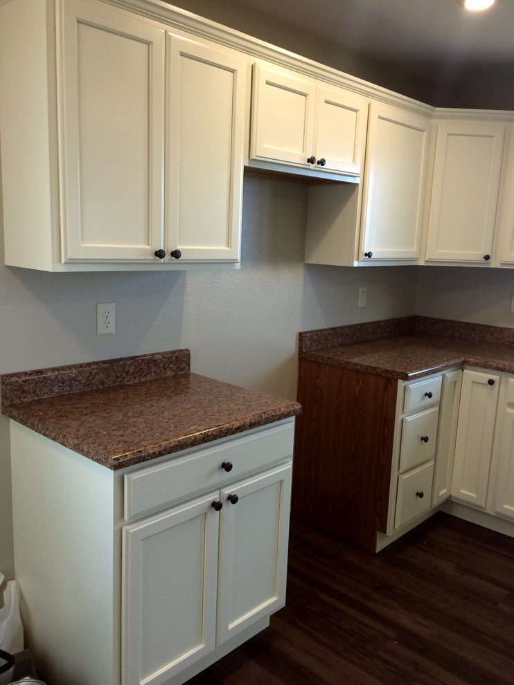 Kitchen - kitchen idea with a drop-in sink, flat-panel cabinets, white cabinets and laminate countertops