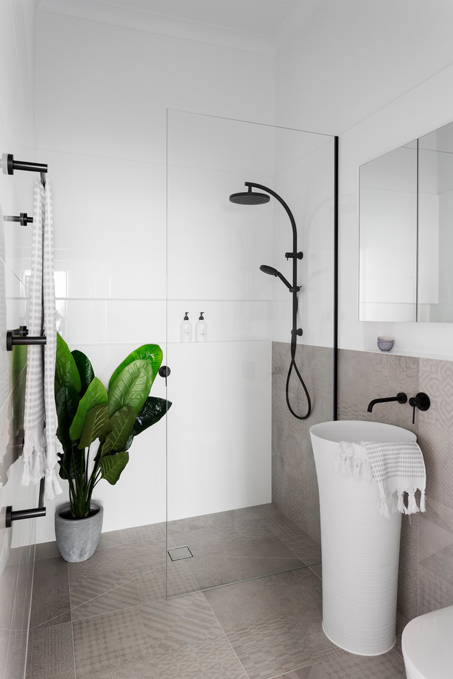 Mid-sized contemporary 3/4 bathroom in Melbourne with flat-panel cabinets, an alcove shower, beige tile, white tile, beige floor, an open shower, a wall-mount toilet, porcelain tile, porcelain floors and a pedestal sink.