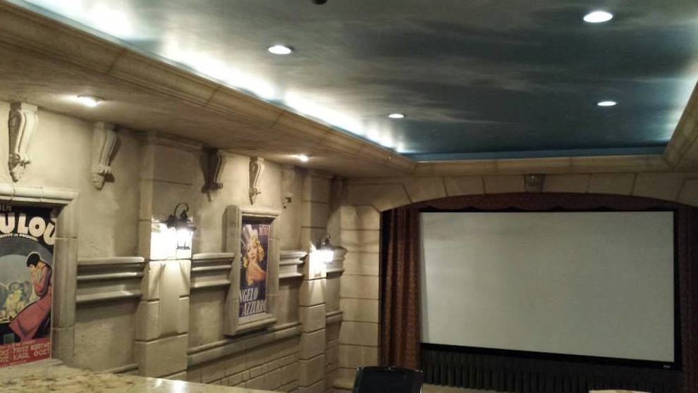 Photo of a mid-sized mediterranean enclosed home theatre in Salt Lake City with beige walls and a projector screen.