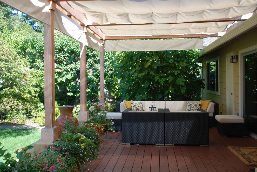 Photo of a large mediterranean backyard deck in San Francisco with a water feature and a pergola.