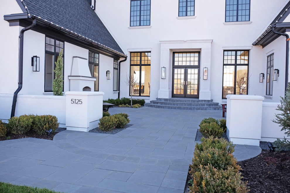 This is an example of a transitional courtyard patio in Minneapolis with natural stone pavers.