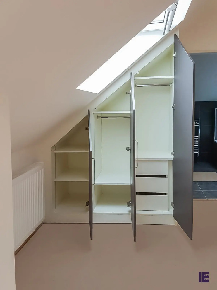 Photo of a small modern built-in wardrobe in London with flat-panel cabinets and brown cabinets.