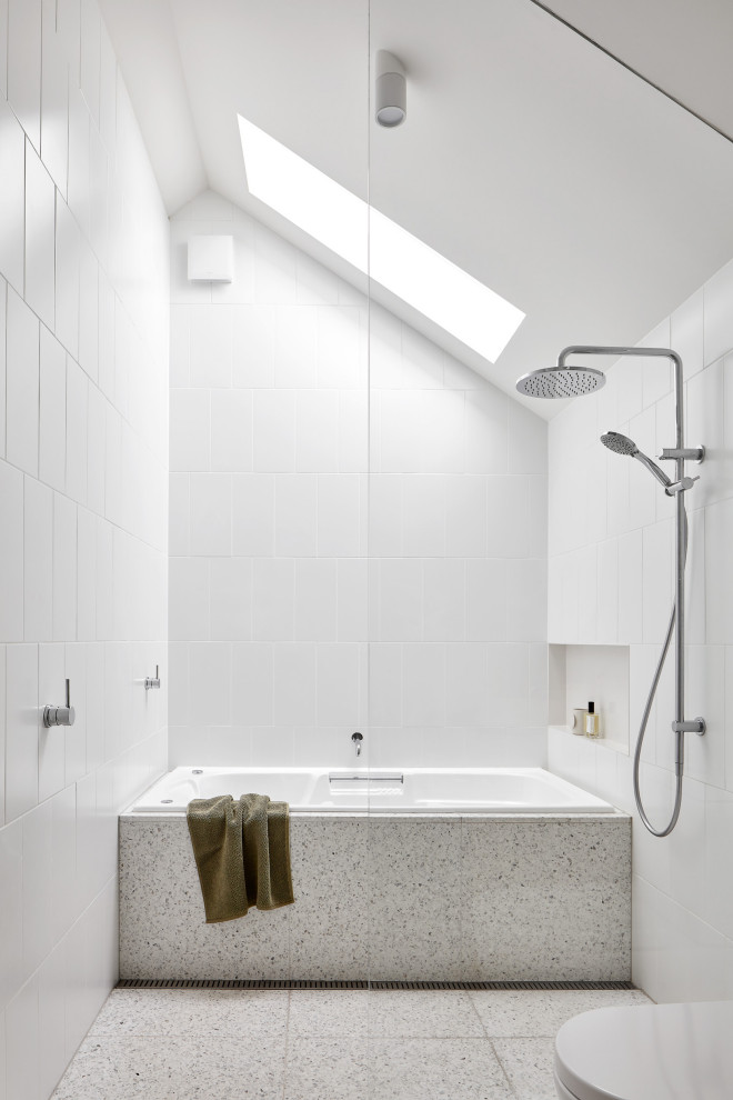 Mid-sized contemporary bathroom in Melbourne with medium wood cabinets, a corner tub, a curbless shower, a two-piece toilet, white tile, porcelain tile, white walls, terrazzo floors, a pedestal sink, wood benchtops, multi-coloured floor, an open shower, brown benchtops, a niche, a single vanity, a floating vanity and panelled walls.