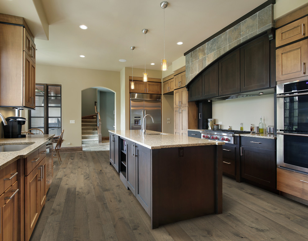 Mid-sized modern galley eat-in kitchen in Los Angeles with a single-bowl sink, recessed-panel cabinets, light wood cabinets, granite benchtops, stainless steel appliances, medium hardwood floors and with island.