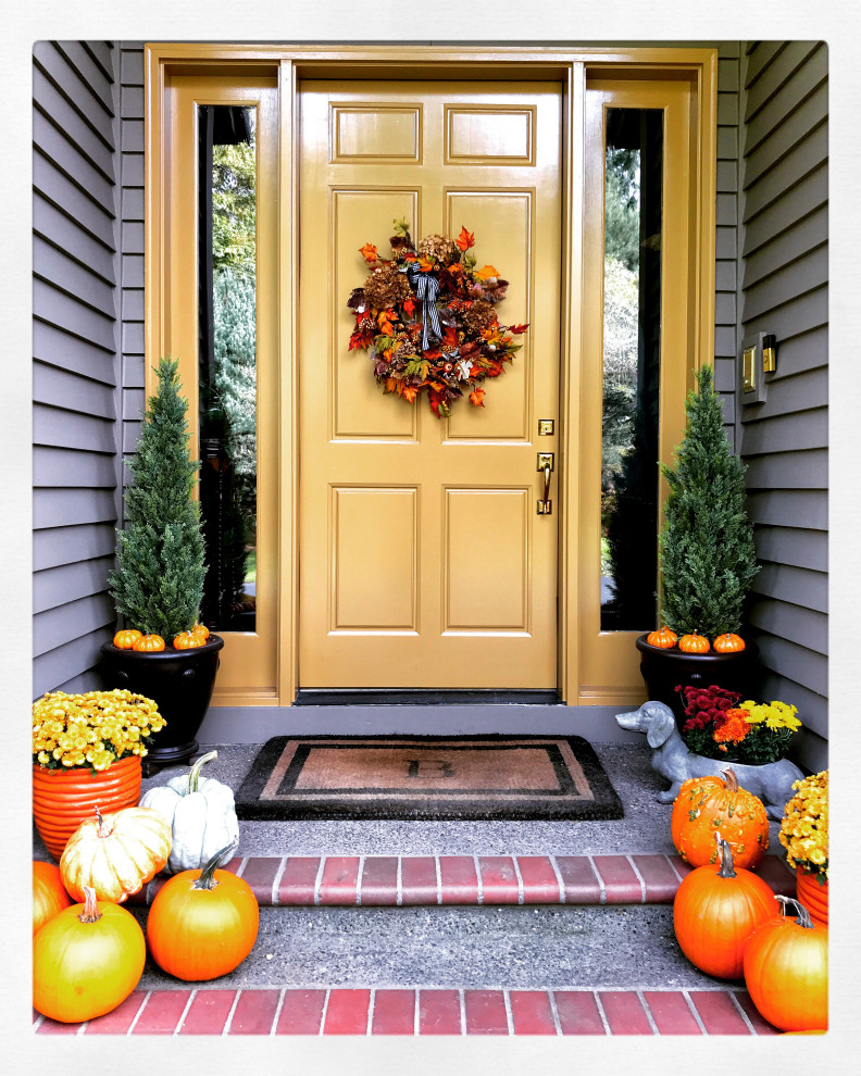 This is an example of a mid-sized traditional front door in Portland with brown walls, brick floors, a single front door, a yellow front door and grey floor.