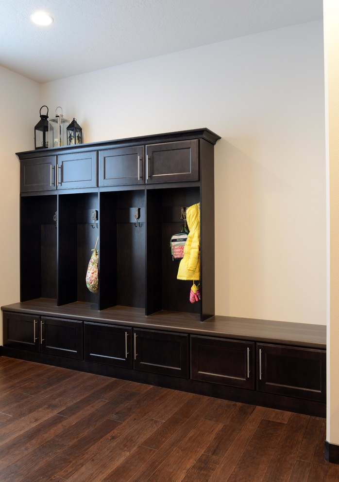 Example of a mid-sized transitional medium tone wood floor entryway design with white walls