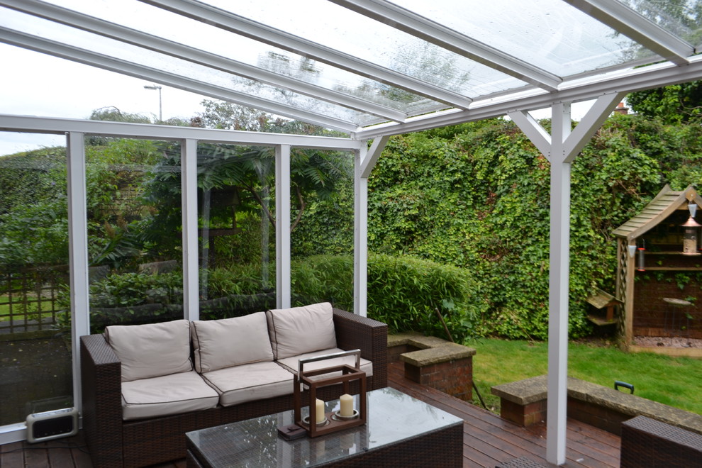 Mid-sized contemporary backyard screened-in verandah in Devon with a pergola.