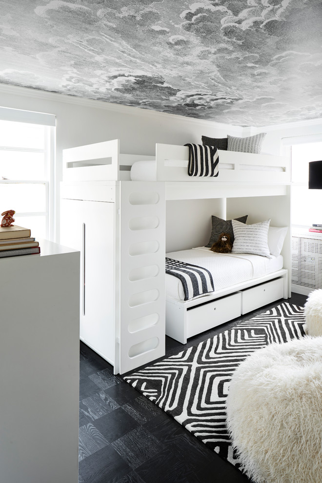 This is an example of a small modern gender-neutral kids' room in New York with white walls, dark hardwood floors and black floor.