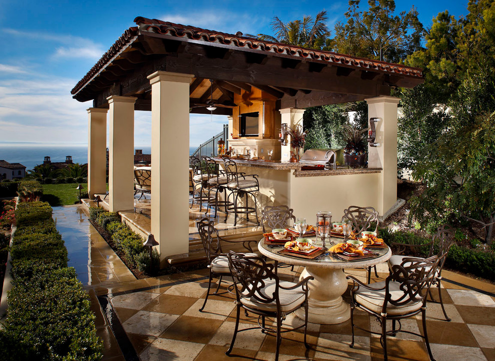 Inspiration for a large mediterranean backyard patio in Orange County with an outdoor kitchen, tile and a gazebo/cabana.