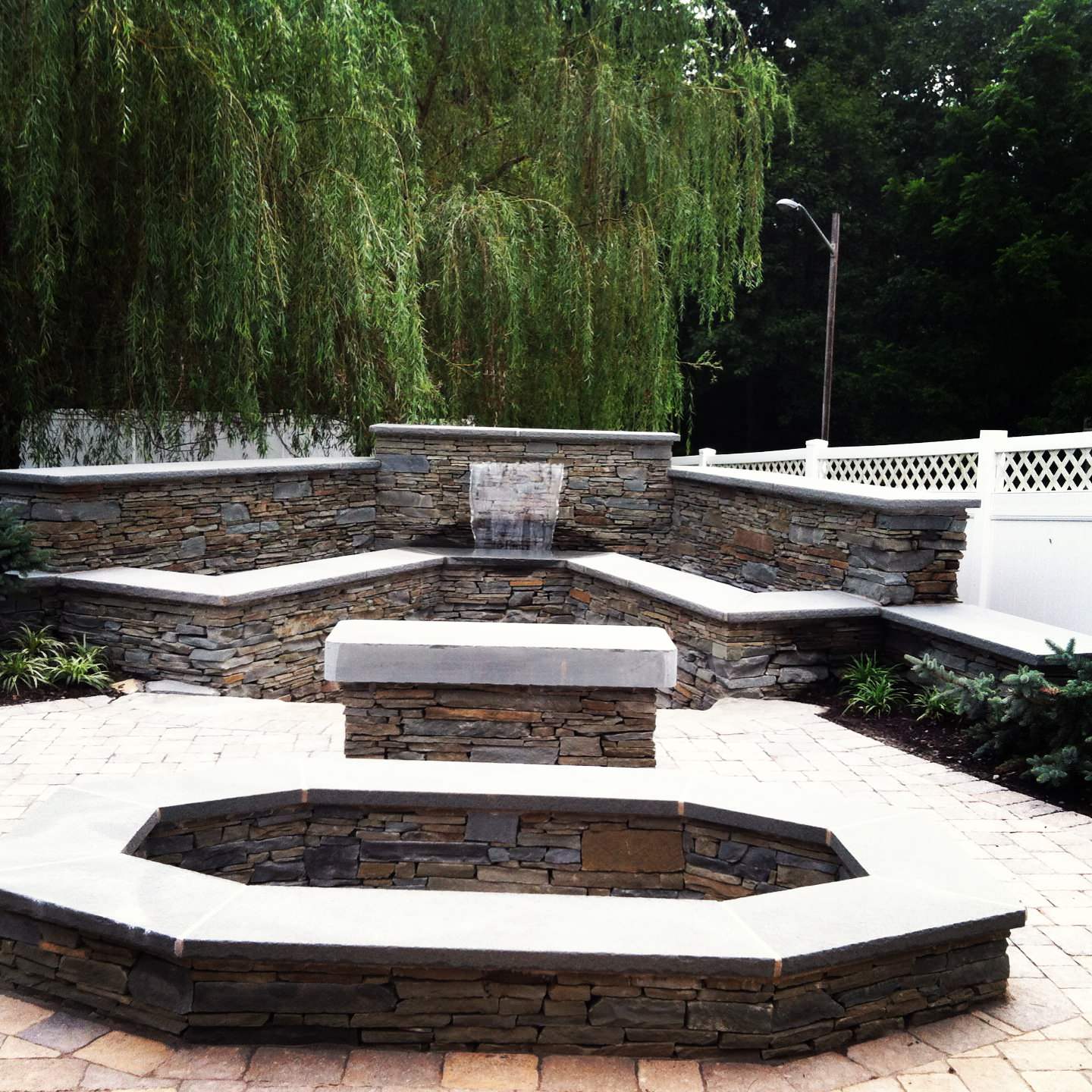 paver patio with waterwall bluestone walls and unique bluestone firepit