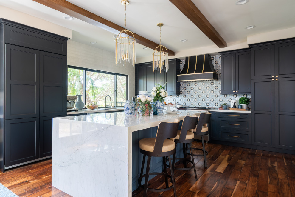 Example of a mid-sized transitional l-shaped dark wood floor, brown floor and exposed beam open concept kitchen design in Denver with an undermount sink, recessed-panel cabinets, black cabinets, quartz countertops, blue backsplash, ceramic backsplash, stainless steel appliances, an island and white countertops