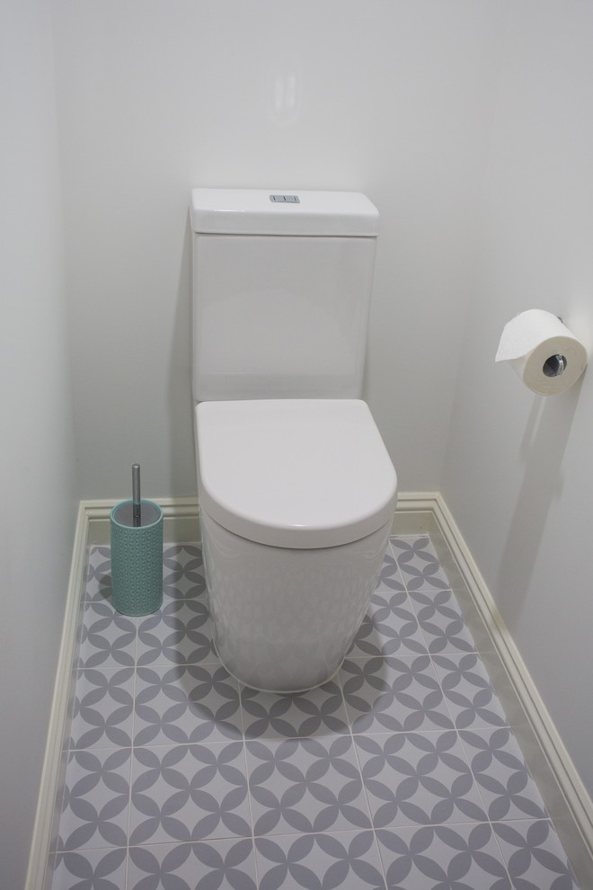 Inspiration for a small traditional powder room in Brisbane with a one-piece toilet, ceramic tile, white walls, porcelain floors, blue floor and white benchtops.