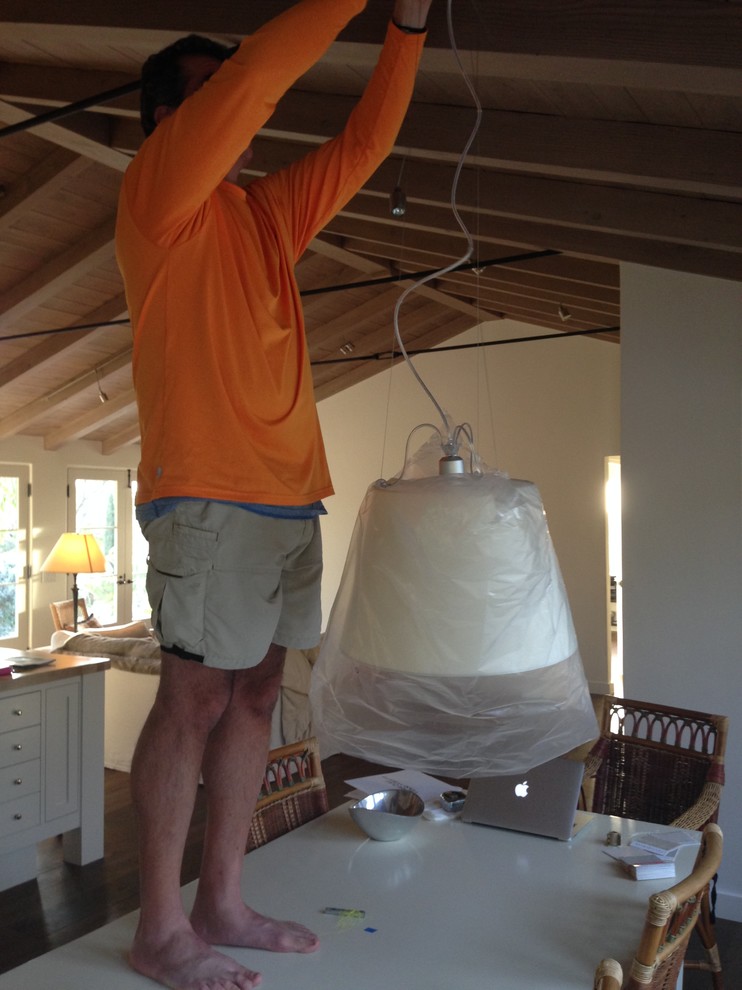 How high should a light with a shade be hung over a table?