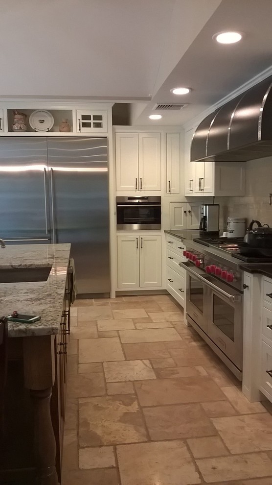 Example of a transitional kitchen design in Minneapolis with recessed-panel cabinets, white cabinets, granite countertops and beige backsplash