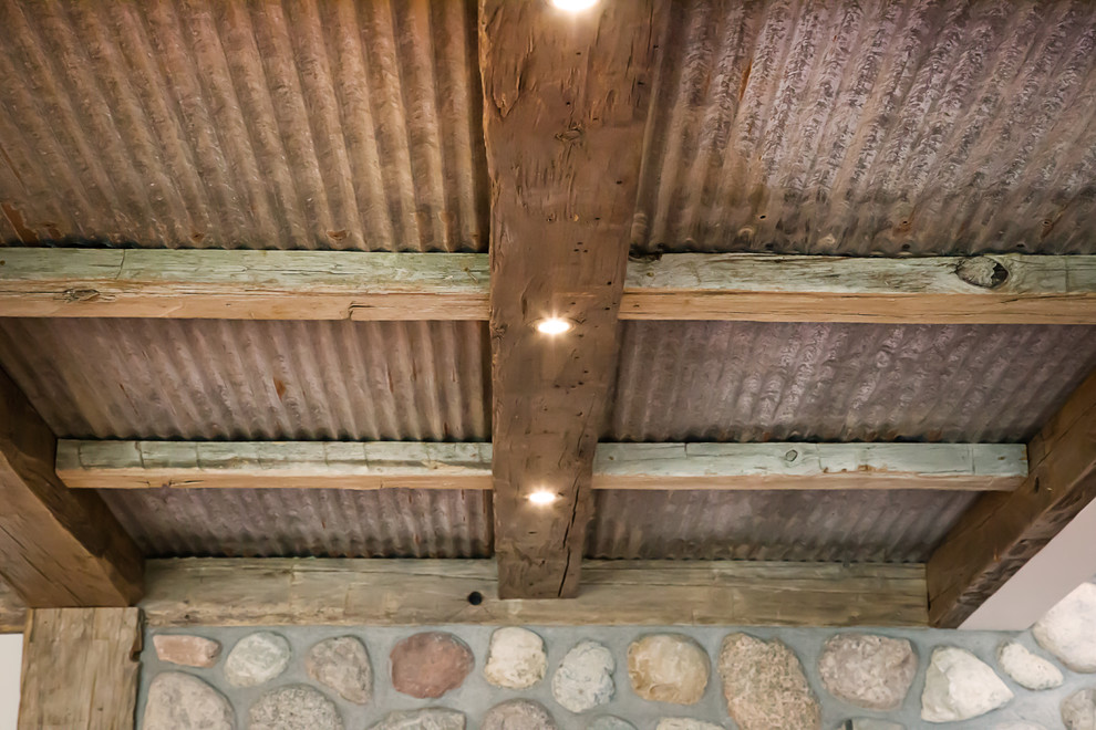 Home design - large rustic walk-out dark wood floor home design idea with white walls, a standard fireplace and a stone fireplace