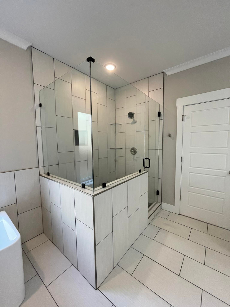 Photo of a mid-sized country master bathroom in Birmingham with shaker cabinets, white cabinets, a freestanding tub, a two-piece toilet, gray tile, ceramic tile, grey walls, ceramic floors, an undermount sink, granite benchtops, grey floor, a hinged shower door, white benchtops, a shower seat, a double vanity and a built-in vanity.