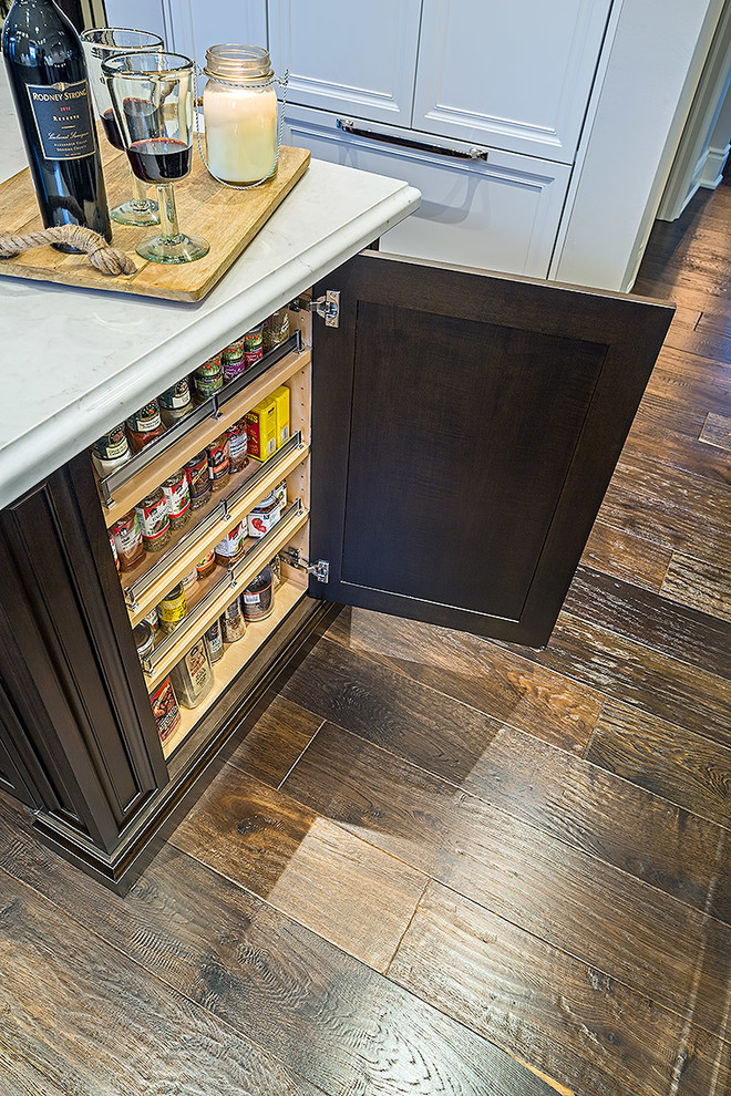 Inspiration for a mid-sized transitional l-shaped enclosed kitchen remodel in Toronto with white cabinets, quartz countertops and an island