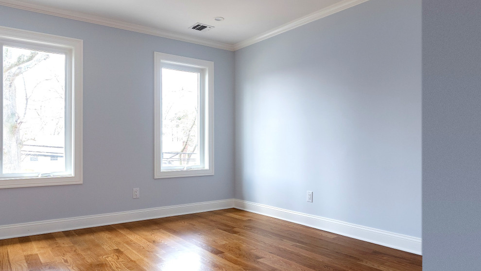 Corner Bedroom with Windows and Wood Floors