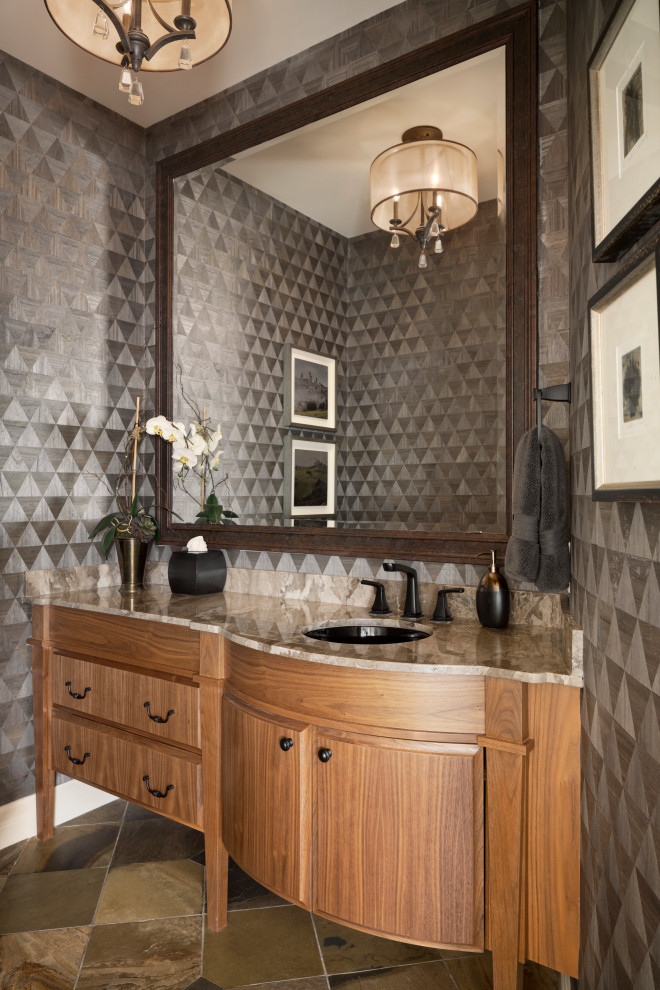 Photo of a medium sized traditional cloakroom in Calgary with freestanding cabinets, brown cabinets, black walls, slate flooring, a submerged sink, marble worktops, brown floors, brown worktops, a built in vanity unit and wallpapered walls.