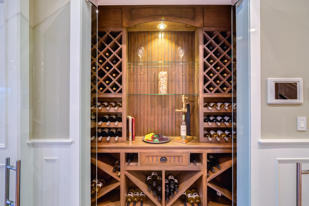 This is an example of a small transitional wine cellar in Los Angeles with storage racks, ceramic floors and brown floor.