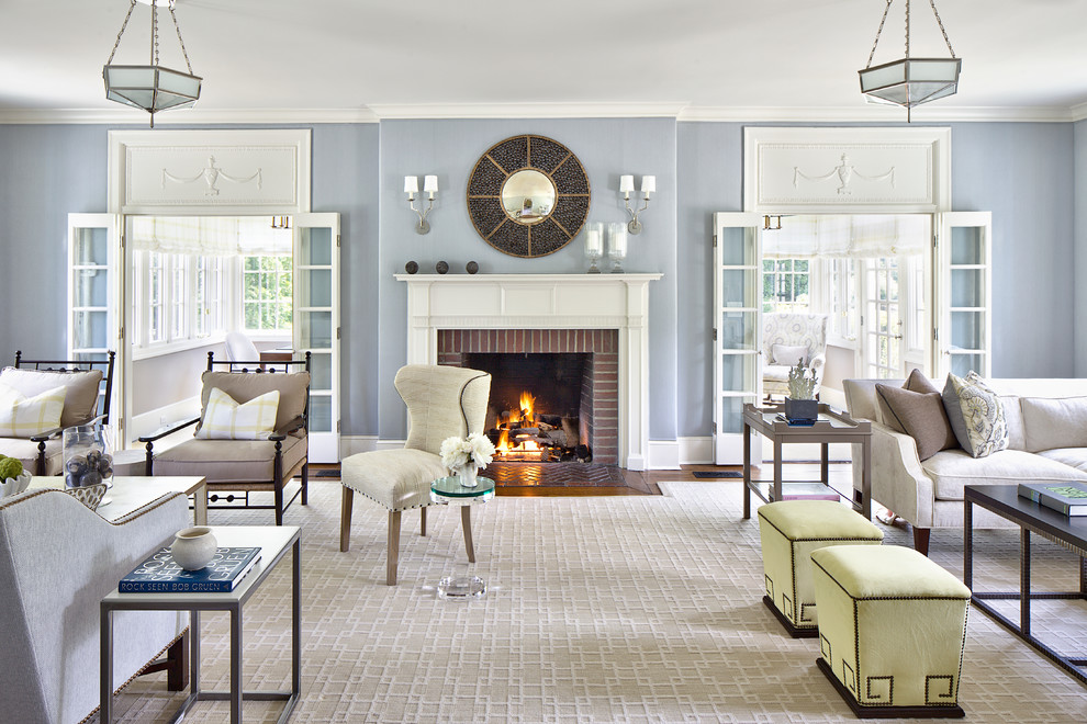 Living room - large traditional formal medium tone wood floor living room idea in New York with blue walls, a brick fireplace, no tv and a standard fireplace