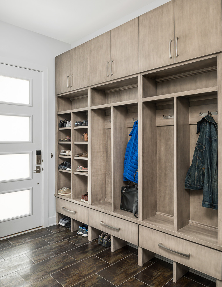 Design ideas for a mid-sized contemporary mudroom in Chicago with white walls, porcelain floors, a single front door, a white front door and brown floor.