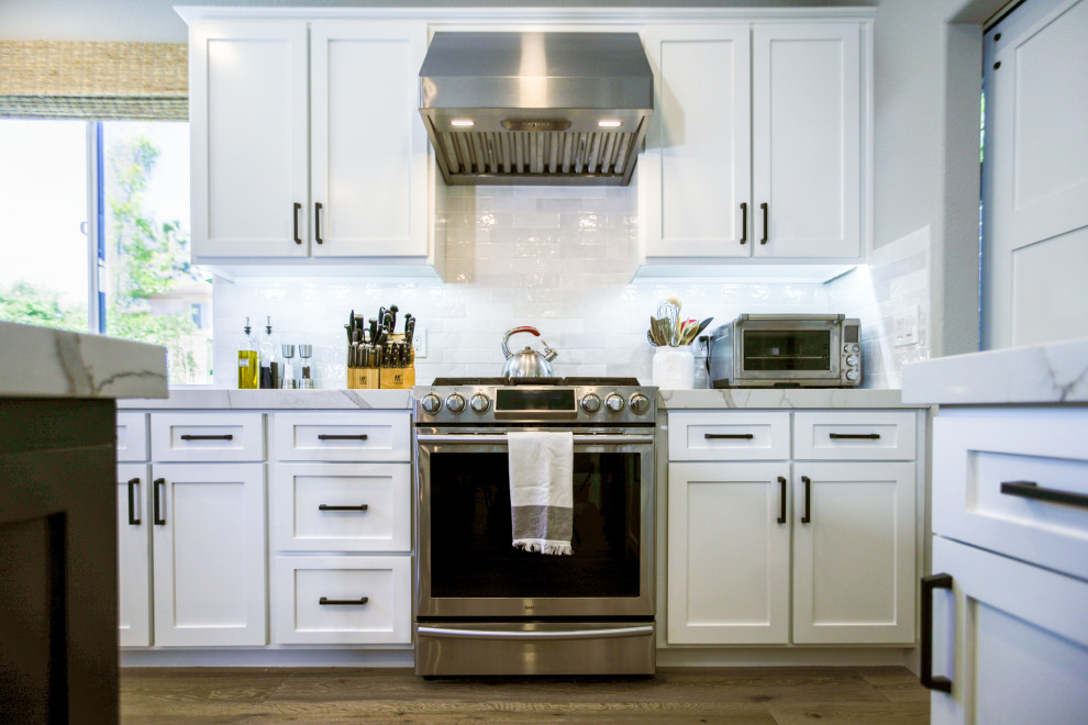 Design ideas for a modern eat-in kitchen in Sacramento with an undermount sink, quartz benchtops, white splashback, ceramic splashback, stainless steel appliances, with island and beige benchtop.