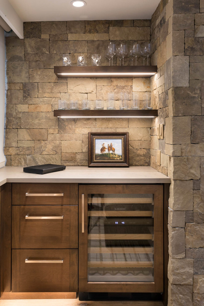 This is an example of a wet bar in Denver with dark wood cabinets, quartzite benchtops, stone tile splashback and grey benchtop.