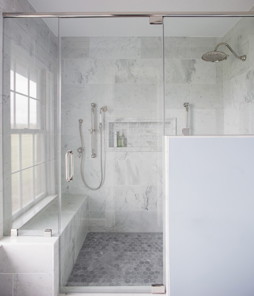 Design ideas for a mid-sized traditional master bathroom in Atlanta with raised-panel cabinets, white cabinets, a one-piece toilet, gray tile, marble, blue walls, porcelain floors, an undermount sink, marble benchtops, grey floor, a hinged shower door and white benchtops.