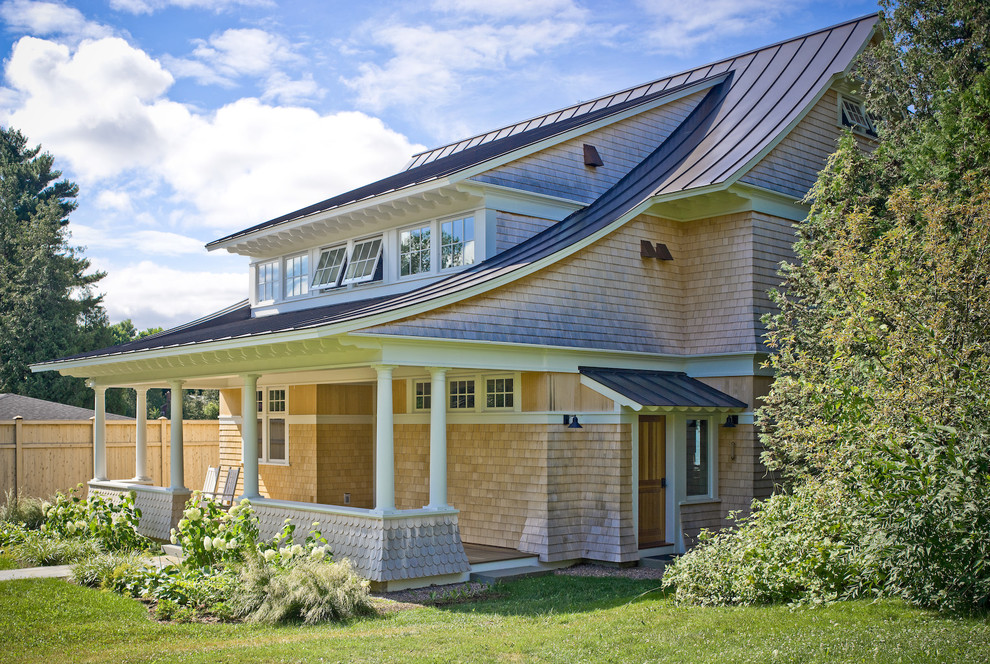 Photo of a large traditional two-storey house exterior in Burlington with wood siding and a metal roof.