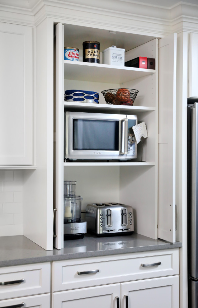 Kitchen - transitional kitchen idea in Chicago with shaker cabinets, white cabinets, quartz countertops, white backsplash, stainless steel appliances and gray countertops