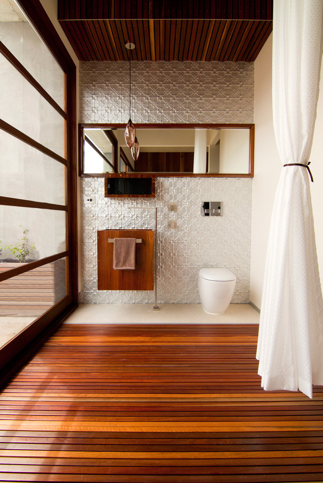 Inspiration for a contemporary powder room in Other with gray tile, white walls and medium hardwood floors.