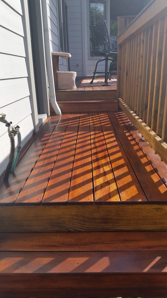 Example of a mid-sized transitional backyard deck design in Austin with a fire pit and no cover